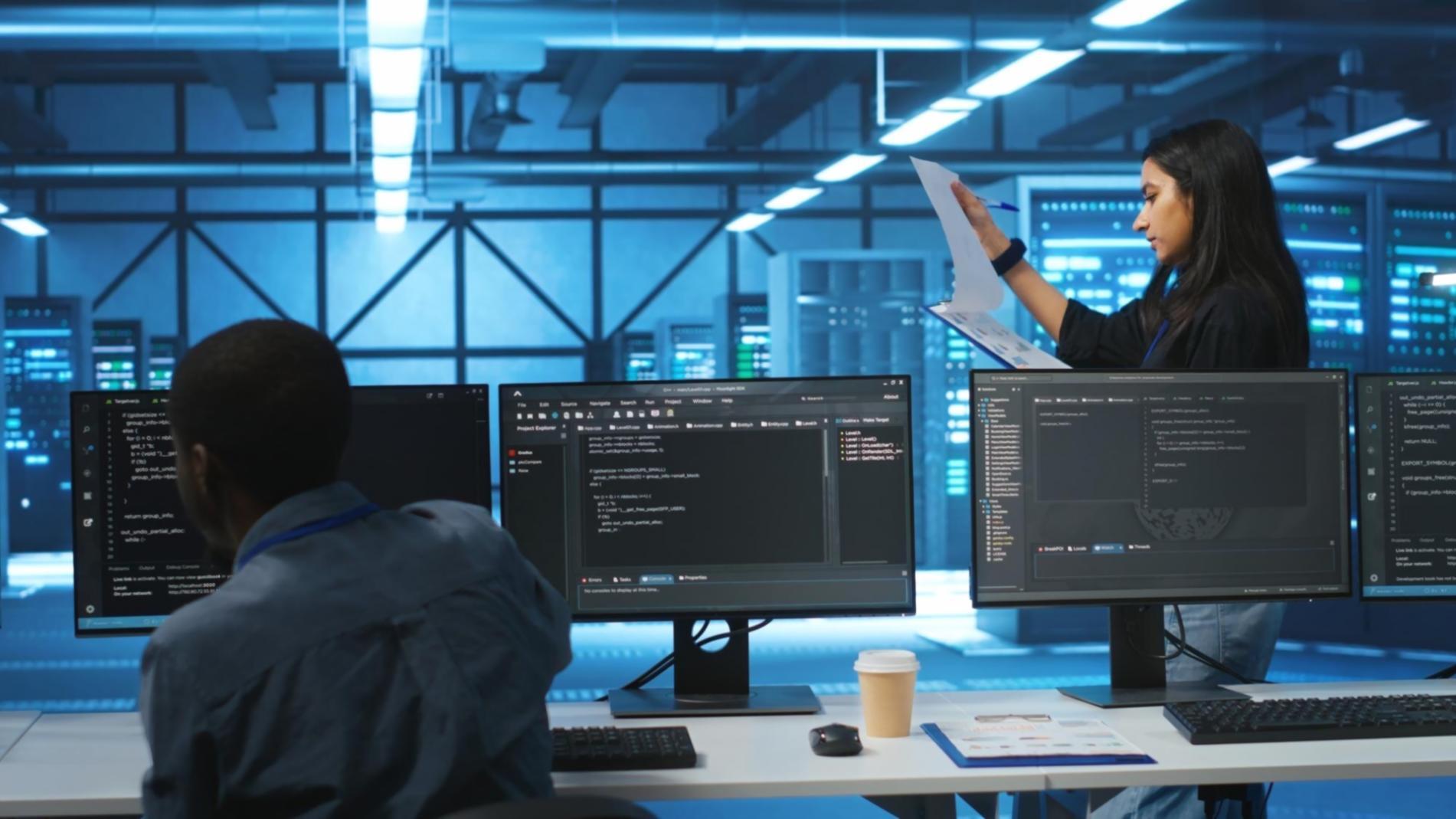 Modern workspace with multiple screens showing JavaScript code and development tools